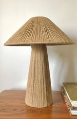Load image into Gallery viewer, A beige table lamp with a unique rope-like texture on both the base and shade, placed on a wooden surface.