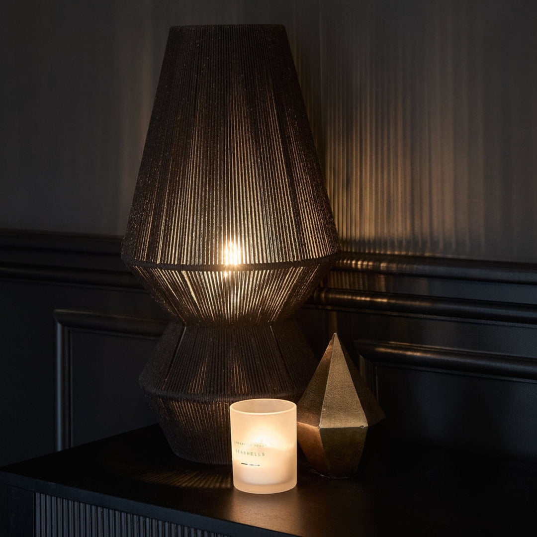 Obelisk table lamp illuminated in dark room