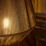 Load image into Gallery viewer, Close up of black rope and warm light